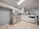 Clean kitchen with white cabinetry, tile flooring, and breakfast bar seating at 22829 Saint Thomas Cir, Lutz, FL 33549