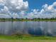 Expansive view of the lake with fluffy clouds reflecting in the calm water at 22829 Saint Thomas Cir, Lutz, FL 33549