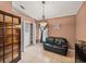Living room with black sofa and closet; perfect for relaxation at 22829 Saint Thomas Cir, Lutz, FL 33549