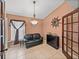 Cozy living room with a black sofa, unique decor, and tile flooring at 22829 Saint Thomas Cir, Lutz, FL 33549