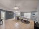 Inviting living room featuring tile flooring, a ceiling fan, and an open layout with bright, natural light at 22829 Saint Thomas Cir, Lutz, FL 33549