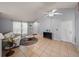 Bright living room with tile floors, high ceilings, ceiling fan, and entry door at 22829 Saint Thomas Cir, Lutz, FL 33549