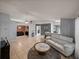 Open-concept living room featuring tile floors, neutral paint, and a view of the kitchen at 22829 Saint Thomas Cir, Lutz, FL 33549