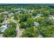 Aerial view of a neighborhood with mature trees, and a scenic lake view at 2308 Cape Bend Ave, Tampa, FL 33613