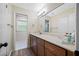 Bathroom featuring dual vanity, hardwood floors, and walk-in shower at 2308 Cape Bend Ave, Tampa, FL 33613