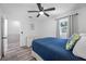 Bedroom with hardwood floors, natural light, and blue bedding at 2308 Cape Bend Ave, Tampa, FL 33613