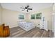 Bright bedroom features updated floors, ceiling fan, and a window that lets in natural light at 2308 Cape Bend Ave, Tampa, FL 33613