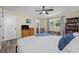 Bedroom featuring hardwood floors, queen bed, ceiling fan, natural light, dresser and bookcase at 2308 Cape Bend Ave, Tampa, FL 33613