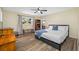 Bedroom with hardwood floors, a queen bed, dresser, and connecting door to living room at 2308 Cape Bend Ave, Tampa, FL 33613