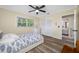 Bedroom with wood floors, ceiling fan and closet is adjacent to the bathroom at 2308 Cape Bend Ave, Tampa, FL 33613