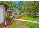 Charming single-story home with a wooden front door and brick facade, enhanced by a walkway at 2308 Cape Bend Ave, Tampa, FL 33613
