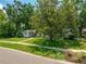 Inviting single-story home featuring a well-maintained lawn and mature trees at 2308 Cape Bend Ave, Tampa, FL 33613