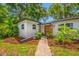 Charming single-story home with a wooden front door and brick facade, enhanced by a walkway at 2308 Cape Bend Ave, Tampa, FL 33613