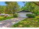Home exterior featuring a long driveway, beautiful lawn, and established shrubbery at 2308 Cape Bend Ave, Tampa, FL 33613