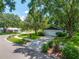 Well-manicured front yard with a long driveway, mature trees, and green shrubs at 2308 Cape Bend Ave, Tampa, FL 33613