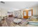 Spacious living room with hardwood floors, cozy seating, and front door with beautiful glass features at 2308 Cape Bend Ave, Tampa, FL 33613