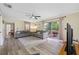 Comfortable living room with wood floors, neutral tones, and a sliding glass door to the backyard at 2308 Cape Bend Ave, Tampa, FL 33613