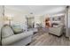 Open-concept living area with hardwood floors, neutral decor, and access to dining area at 2308 Cape Bend Ave, Tampa, FL 33613