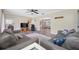 Open-concept living room with hardwood floors, sofas, TV, with connecting dining and sun rooms at 2308 Cape Bend Ave, Tampa, FL 33613