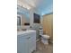 A bathroom features a white vanity, decorative wall art, and a shower with a gold curtain at 2848 Homewood St, Clearwater, FL 33759
