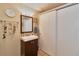 Bathroom with a vanity sink, decorative mirror, and closet with sliding doors at 2848 Homewood St, Clearwater, FL 33759