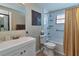 Bathroom showcasing a toilet, vanity, shower curtain and tiled shower at 2848 Homewood St, Clearwater, FL 33759