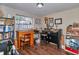A room features a desk with a chair, a work station, and dark wood flooring at 2848 Homewood St, Clearwater, FL 33759