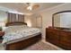 Spacious bedroom featuring a ceiling fan, carpet flooring, and dresser with mirror at 2848 Homewood St, Clearwater, FL 33759