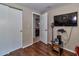 A room features a wall-mounted television, closet doors, and an open doorway at 2848 Homewood St, Clearwater, FL 33759