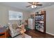 Bedroom featuring wood floors, ceiling fan and large built-in storage cabinet at 2848 Homewood St, Clearwater, FL 33759