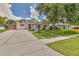 Inviting exterior of a well-kept home featuring a long driveway and verdant front lawn at 2848 Homewood St, Clearwater, FL 33759