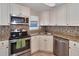 Updated kitchen with stainless steel appliances and granite countertops at 2848 Homewood St, Clearwater, FL 33759