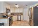 Well lit kitchen showcasing stainless steel appliances, granite countertops, tile backsplash, and ample cabinet space at 2848 Homewood St, Clearwater, FL 33759