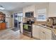 Modern kitchen with stainless steel appliances, granite countertops, and outdoor access at 2848 Homewood St, Clearwater, FL 33759