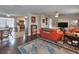Open living room with wood floors, stylish rug, and comfortable seating adjacent to kitchen at 2848 Homewood St, Clearwater, FL 33759