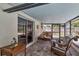 An enclosed patio features wicker furniture and views of the backyard at 2848 Homewood St, Clearwater, FL 33759