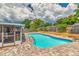 Sparkling private pool surrounded by a brick patio and screened enclosure, perfect for relaxation at 2848 Homewood St, Clearwater, FL 33759
