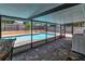 A covered patio features a pool and patio furniture with a washer and dryer at 2848 Homewood St, Clearwater, FL 33759
