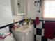 Bathroom featuring sink and vanity, black and white checkered walls, and a mirror at 2909 N 11Th St, Tampa, FL 33605
