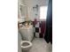 Bathroom with sink and vanity, toilet, black and white checkered walls, and window at 2909 N 11Th St, Tampa, FL 33605