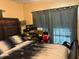 Bedroom featuring a bed with shoe box storage near the window at 2909 N 11Th St, Tampa, FL 33605