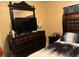 Bedroom featuring a bed and dresser with a large mirror, providing a glimpse into the room's features at 2909 N 11Th St, Tampa, FL 33605