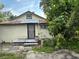 The back of the house shows a door and a window at 2909 N 11Th St, Tampa, FL 33605
