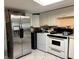 Functional kitchen with white appliances, and overhead cabinets at 2909 N 11Th St, Tampa, FL 33605