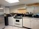 Functional kitchen with white appliances, and overhead cabinets at 2909 N 11Th St, Tampa, FL 33605