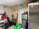 Functional kitchen area with modern appliances, complemented by an assortment of cleaning supplies and pantry items at 2909 N 11Th St, Tampa, FL 33605