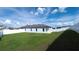 Spacious backyard with lush green lawn, a white fence for privacy, and a well-maintained home exterior at 29245 Fedora Cir, Brooksville, FL 34602