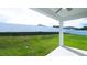 View of covered patio and fenced backyard with green grass at 29245 Fedora Cir, Brooksville, FL 34602