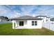 Rear of the home with patio, sliding glass doors, and fenced-in backyard at 29245 Fedora Cir, Brooksville, FL 34602