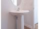 Bathroom featuring a pedestal sink, oval mirror and access to a bedroom or hallway at 29245 Fedora Cir, Brooksville, FL 34602